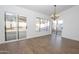 Bright living room features wood-look tile floors, contemporary light fixture, and slider to backyard at 925 E Wagoner Rd, Phoenix, AZ 85022