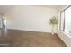 Expansive living room featuring wood-look tile floors, vaulted ceilings, and a view of the backyard at 925 E Wagoner Rd, Phoenix, AZ 85022