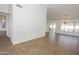 Open living room boasts wood-look tile flooring, a modern light fixture, and slider to backyard at 925 E Wagoner Rd, Phoenix, AZ 85022