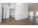 Open concept living room featuring wood-look tile floors, a contemporary light fixture, and slider to backyard at 925 E Wagoner Rd, Phoenix, AZ 85022
