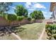Backyard with greenery, bushes, grass, and a brick wall at 10071 W Angels Ln, Peoria, AZ 85383
