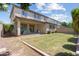 A two-story house with a covered patio and a lawn in the backyard at 10071 W Angels Ln, Peoria, AZ 85383