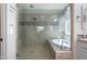 Modern bathroom with a glass-enclosed shower, luxurious soaking tub, and contemporary fixtures at 10071 W Angels Ln, Peoria, AZ 85383