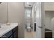 Bathroom with a sink, toilet, and walk-in closet, offering functionality and storage in a compact space at 10071 W Angels Ln, Peoria, AZ 85383