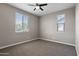 This cozy bedroom has bright windows, neutral tones, and plush carpeting that provides a comfortable and inviting space at 10071 W Angels Ln, Peoria, AZ 85383
