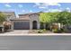 Charming home with a well-manicured lawn, desert landscaping, and a spacious two-car garage enhancing curb appeal at 10071 W Angels Ln, Peoria, AZ 85383