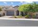 Charming home with a well-manicured lawn, desert landscaping, and a spacious two-car garage enhancing curb appeal at 10071 W Angels Ln, Peoria, AZ 85383