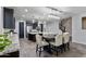 This spacious kitchen features dark cabinets, stainless appliances, a granite island, and a breakfast area at 10071 W Angels Ln, Peoria, AZ 85383