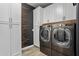 Functional laundry room with modern washer and dryer, storage cabinets, and stylish wall decor at 10071 W Angels Ln, Peoria, AZ 85383