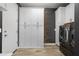 Functional laundry room with modern washer and dryer, storage cabinets, and stylish wall decor at 10071 W Angels Ln, Peoria, AZ 85383