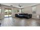 The living room features a ceiling fan, tile floors, many windows, and a comfortable sectional couch at 10071 W Angels Ln, Peoria, AZ 85383
