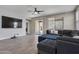 The living room features a ceiling fan, tile floors, many windows, and a comfortable sectional couch at 10071 W Angels Ln, Peoria, AZ 85383