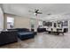 The living room features a ceiling fan, tile floors, many windows, and a comfortable sectional couch at 10071 W Angels Ln, Peoria, AZ 85383