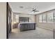 The main bedroom features a large bed, ceiling fan, multiple windows, and a sliding barn door at 10071 W Angels Ln, Peoria, AZ 85383