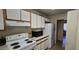 Functional kitchen with essential appliances, including a stove and refrigerator at 10408 W Devonshire Ave, Phoenix, AZ 85037