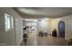 Bright and airy living space adjacent to the kitchen with tiled floors at 10408 W Devonshire Ave, Phoenix, AZ 85037