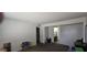 Cozy living room featuring neutral carpet with access to a bathroom and doorway at 10408 W Devonshire Ave, Phoenix, AZ 85037