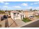Wide aerial shot of a home showcasing its well-kept lawn, tile roof, and convenient driveway at 11056 W Lane Ave, Glendale, AZ 85307