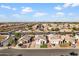 High aerial view capturing several homes in a suburban neighborhood, with desert scenery in the background at 11056 W Lane Ave, Glendale, AZ 85307