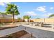 Attractive backyard with a brick patio, firepit, palm trees, and meticulous landscaping at 11056 W Lane Ave, Glendale, AZ 85307