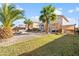 Spacious backyard with patio, palm trees, firepit and artificial grass at 11056 W Lane Ave, Glendale, AZ 85307
