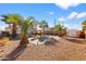 Private backyard showcasing a firepit, palm trees, and ample space for entertaining at 11056 W Lane Ave, Glendale, AZ 85307
