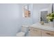 Clean bathroom features a modern vanity with light wood finish and a decorative plant accent at 11056 W Lane Ave, Glendale, AZ 85307