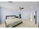 Spacious bedroom with a ceiling fan, wood-look flooring, and ample natural light at 11056 W Lane Ave, Glendale, AZ 85307