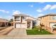 Charming two-story home featuring a well-manicured lawn and a welcoming entryway with a tiled roof at 11056 W Lane Ave, Glendale, AZ 85307