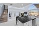 Open-concept kitchen with island seating, white cabinets, and a staircase leading to the upper level at 11056 W Lane Ave, Glendale, AZ 85307