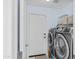 Well-equipped laundry room features modern washer and dryer units, plus convenient access door at 11056 W Lane Ave, Glendale, AZ 85307