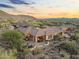Stunning aerial view of a luxury home with a backyard oasis, desert landscape, and panoramic views at 11400 E Helm Dr, Scottsdale, AZ 85255