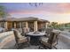 Relaxing backyard with a fire pit, seating, and lush desert landscaping perfect for outdoor entertaining at 11400 E Helm Dr, Scottsdale, AZ 85255