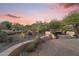 Enjoy the desert views from the backyard seating area with a charming fire pit feature at 11400 E Helm Dr, Scottsdale, AZ 85255