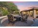 Backyard fire pit with comfortable seating, desert landscaping, and a covered outdoor area perfect for relaxation at 11400 E Helm Dr, Scottsdale, AZ 85255