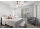 Cozy bedroom with comfortable bed, sitting area, and ample natural light at 11400 E Helm Dr, Scottsdale, AZ 85255