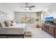 Bright bedroom with neutral tones, plush bedding, and a scenic view through the large window at 11400 E Helm Dr, Scottsdale, AZ 85255