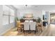 Well-lit dining room features modern decor, wood-style flooring, and serene views at 11400 E Helm Dr, Scottsdale, AZ 85255