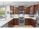 Stylish kitchen showcasing granite countertops, stainless steel appliances, and custom cabinetry at 11400 E Helm Dr, Scottsdale, AZ 85255