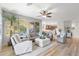 Open-concept living room with natural light, sleek wood floors, and views into the gourmet kitchen at 11400 E Helm Dr, Scottsdale, AZ 85255