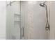 Walk-in shower featuring neutral tiling, mosaic accents, and rainfall shower head at 11400 E Helm Dr, Scottsdale, AZ 85255