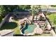 Beautiful backyard featuring a freeform pool with rock waterfall, desert landscaping, and lush green grass at 115 E Spur Ave, Gilbert, AZ 85296
