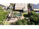 Private backyard boasts a sparkling pool, mature palm trees, and desert landscaping for relaxed outdoor living at 115 E Spur Ave, Gilbert, AZ 85296