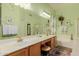 Spacious bathroom featuring dual sinks, a vanity area, and a separate tub and shower at 115 E Spur Ave, Gilbert, AZ 85296