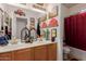 Classic bathroom featuring double sinks, a spacious countertop, framed with car-themed wall art and a shower-tub combo at 115 E Spur Ave, Gilbert, AZ 85296