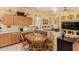 Cozy dining area with a wooden table, seating for four and a view of the living space at 115 E Spur Ave, Gilbert, AZ 85296