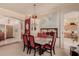 Elegant dining area with a stylish chandelier and seating for six, perfect for Gathering meals and entertaining at 115 E Spur Ave, Gilbert, AZ 85296