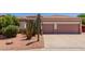 Inviting front exterior featuring desert landscaping, complete with a two-car garage and attractive curb appeal at 115 E Spur Ave, Gilbert, AZ 85296