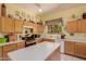 Well-lit kitchen featuring wooden cabinets, white countertops and a window overlooking the outdoors at 115 E Spur Ave, Gilbert, AZ 85296