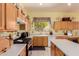 Charming kitchen with white appliances, wooden cabinets and a large sink at 115 E Spur Ave, Gilbert, AZ 85296